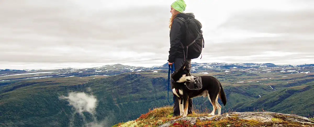 veterinary nurse hiking ith a dog in Norway